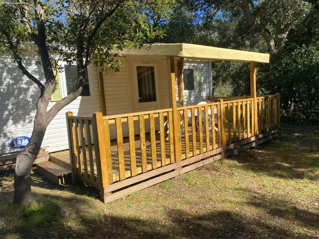 Second static home nestled among trees at Ernella Camping